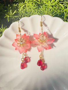 Shrink Plastic Red Lotus Flowers with Seedpod and Crystal Drop Dangled Earrings, Zen Gift, Handmade Earrings, Zen Earrings These handmade earrings feature shrink plastic Red lotus flowers, each adorned with a delicate seedpod and sparkling crystal drops. The lotus flower is a symbol of purity, enlightenment, and rebirth in many Eastern cultures, making these earrings a perfect gift for someone looking to infuse their life with Zen principles.  The earrings are carefully crafted with attention to Jewellery Gift Ideas, Red Flower Drop Earrings, Red Dangle Flower Earrings For Valentine's Day, Handmade Red Flower Earrings For Gift, Handmade Red Flower Earrings As Gift, Red Flower Earrings For Gift, Red Flower Earrings As Gift, Valentine's Day Gift Red Flower Earrings, Red Flower Earrings With Ear Wire For Gift