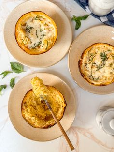 three bowls with food in them sitting on a table