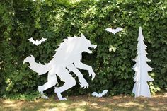 two metal sculptures in the shape of animals and trees