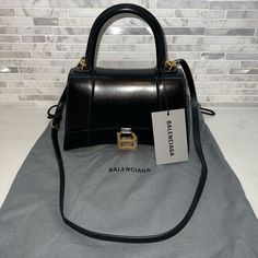 Balenciaga Hourglass Top Handle Small Black Bag Luxury Black Baguette Bag With Multiple Compartments, Luxury Black Trendy Baguette Bag, Luxury Large Capacity Black Baguette Bag, Luxury Black Baguette Bag With Single Compartment, Balenciaga Hourglass Bag Outfit, Balenciaga Hourglass Bag, Small Black Bag, Bags Balenciaga, Balenciaga Handbags