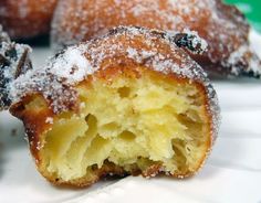 powdered sugar covered doughnuts on a plate