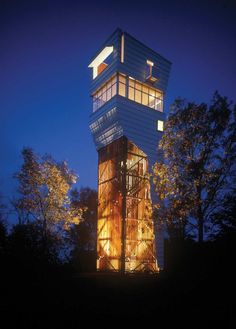 a tall tower with windows lit up at night