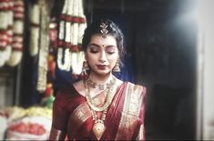 a woman in a red and gold sari