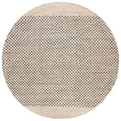 a round rug with black and white dots on the bottom, in front of a white background