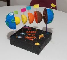 a cake that is on top of a table with some candles in the shape of planets