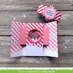 an open christmas card with snowflakes on it and a paper clock in the center