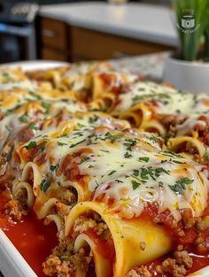 lasagna casserole with meat and cheese in a white dish on a table