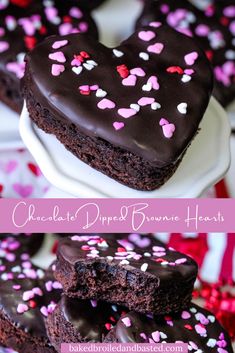 heart shaped brownies with chocolate frosting and sprinkles are on a plate