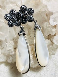 Dazzling pair of sterling silver, pearl & marcasite pierced, push back earrings from the art nouveau period. These earrings are large, measuring 56.30mm Long. Top flower 15.10mm round. Oval drop 40.20 mmm with attached o-ring. With 7.08mm depth of oval pearl cabachon. Features 25 marcasites each earring. Weighs 14.2 grams. Marked 925 Thai on earrings. Backs marked 925. Tests as sterling silver. Excellent condition. Antique Silver Pearl Earrings For Anniversary, Silver Victorian Pearl Earrings For Anniversary, Victorian Silver Pearl Earrings For Anniversary, Victorian Silver Pearl Drop Earrings, Silver Teardrop Victorian Earrings, Victorian Teardrop Silver Earrings, Victorian Silver Teardrop Earrings, Victorian Style Silver Teardrop Earrings, Edwardian Era