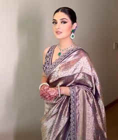 a woman in a purple sari and matching jewelry