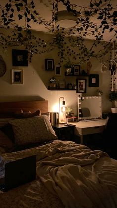 a bed sitting in a bedroom next to a lamp and pictures hanging on the wall