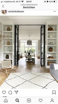 a living room filled with furniture and lots of bookshelves on top of it