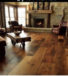 a living room filled with furniture and a fire place in the middle of a room