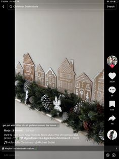 a christmas garland with gingerbread houses and pine cones is displayed on an instagram page