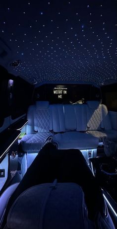 the interior of a vehicle with stars on the ceiling and lights in the passenger seat