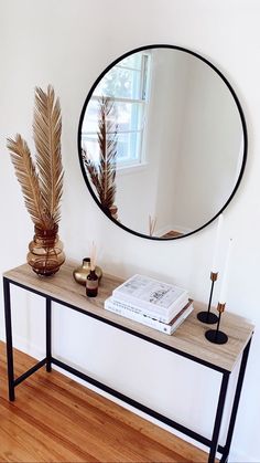 a mirror and some plants on a table