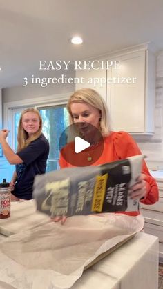 an image of a woman cooking in the kitchen with her daughter and another woman looking on