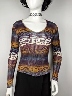 "Very nice vintage ribbed top long sleeve animal pattern from KENZO Jeans. Print leopard, floral and paisley. Cool for rave and everyday look. Size L tag, fits S-XL best (see measurements ) Condition 9/10 Made in Italy Underarm to underarm - 45 cm/17.7\" (the stretches) Length from the back - 55.5 cm/21.8\" (the stretches) Sleeve length - 68 cm/26.7\" (the stretches) All measurements taken with garment lying flat. Vintage sizes vary greatly! We recommend comparing measurements with a similar sty Trendy Fitted Top With Abstract Print, Y2k Multicolor Tops For Fall, Brown Y2k Long Sleeve Tops, Fitted Printed Tops For Fall, Patterned Top With Abstract Print For Fall, Fitted Tops With Abstract Print For Fall, Multicolor Print Tops For Fall, Long Sleeve Paisley Print Patterned Top, Long Sleeve Paisley Print Tops