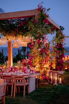 an outdoor dining area with flowers and candles