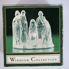 a glass christmas ornament with three figures