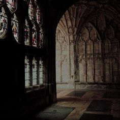 an old building with stained glass windows and stone flooring in the middle of it