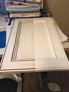 a white desk topped with lots of papers