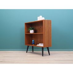 a small wooden shelf with a potted plant on top