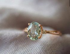 an engagement ring with a large green stone