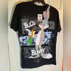 a black t - shirt with bugs and bunny on it hanging from a door frame