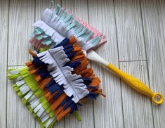 a toothbrush is laying on the floor next to several pieces of fabric that have been folded together