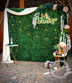 the backdrop is decorated with greenery and flowers