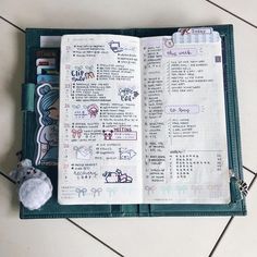 an open planner with stickers and a mouse