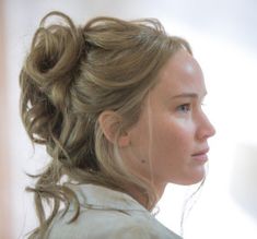 a woman with her hair in a messy ponytail