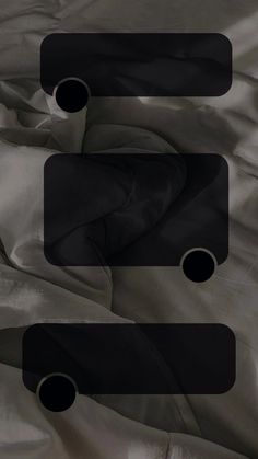 an image of some sort of black object on the bed sheeted material that looks like something out of space