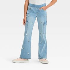 Add standout style to your kid's closet with the Mid-Rise Pull-On Embroidered Cargo Flare Jeans from Cat & Jack™. These light-wash denim jeans are covered with an embroidered pattern for an artistic effect. Tailored from soft and stretchy fabric in a flare fit, these full-length denim jeans are comfortable to wear. The front pockets help provide space to keep small items handy and the full elastic waistband keeps these mid-rise cargo jeans in place. Cat & Jack™: Designed for all children so you Sparkle Leggings, Uniform Pants, Flare Leggings, Girls Leggings, Kids Outfits Girls, Cargo Jeans, Light Wash Denim, Bottom Clothes, Pair Of Pants