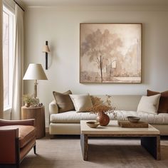 a living room filled with furniture and a painting on the wall above it's coffee table