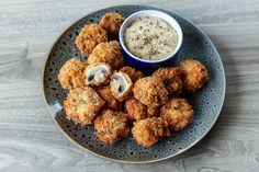 some fried food on a plate with dipping sauce