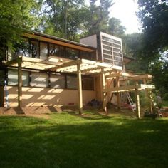 the house is made out of wood and has a large deck on top of it