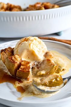 a white plate topped with mashed potatoes covered in gravy and ice cream