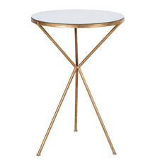 a white table with gold legs and a round glass top on the website for home decor