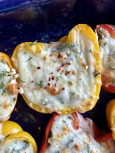 some stuffed peppers with cheese and herbs on them