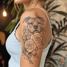 a woman with a dog and roses tattoo on her arm