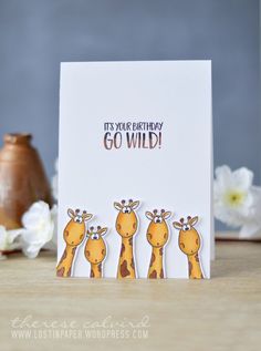 a card with three giraffes and the words it's your birthday go wild