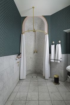 a bathroom with blue walls and white tile