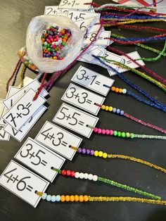 colorful beads and numbers are laid out on the table to be used as counting mats