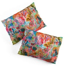 two colorful pillows sitting on top of each other