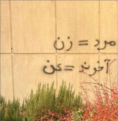 graffiti written on the side of a building in arabic and english writing is seen here