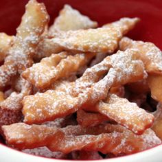 powdered sugar coated food in a red bowl