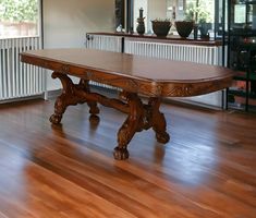 a large wooden table sitting on top of a hard wood floor