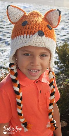 a little boy wearing a knitted hat with ears